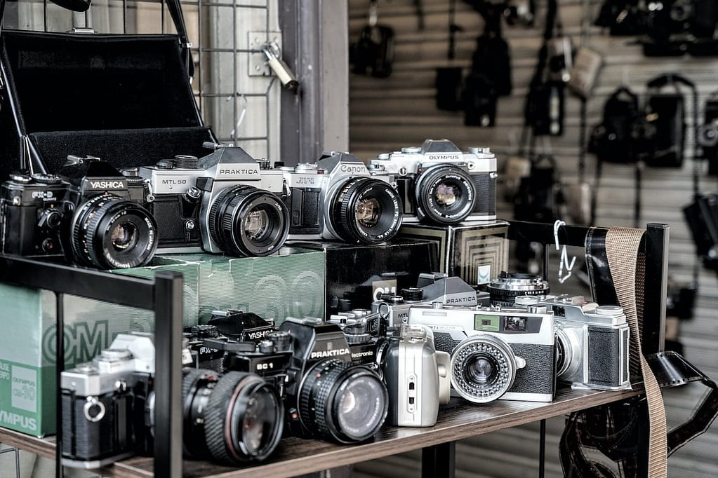 plusieurs appareils photo sur une étagère d'un magasin