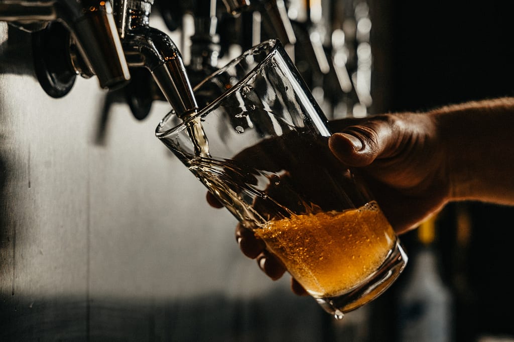 verre de bière qui se rempli grâce à une tireuse dans un bar