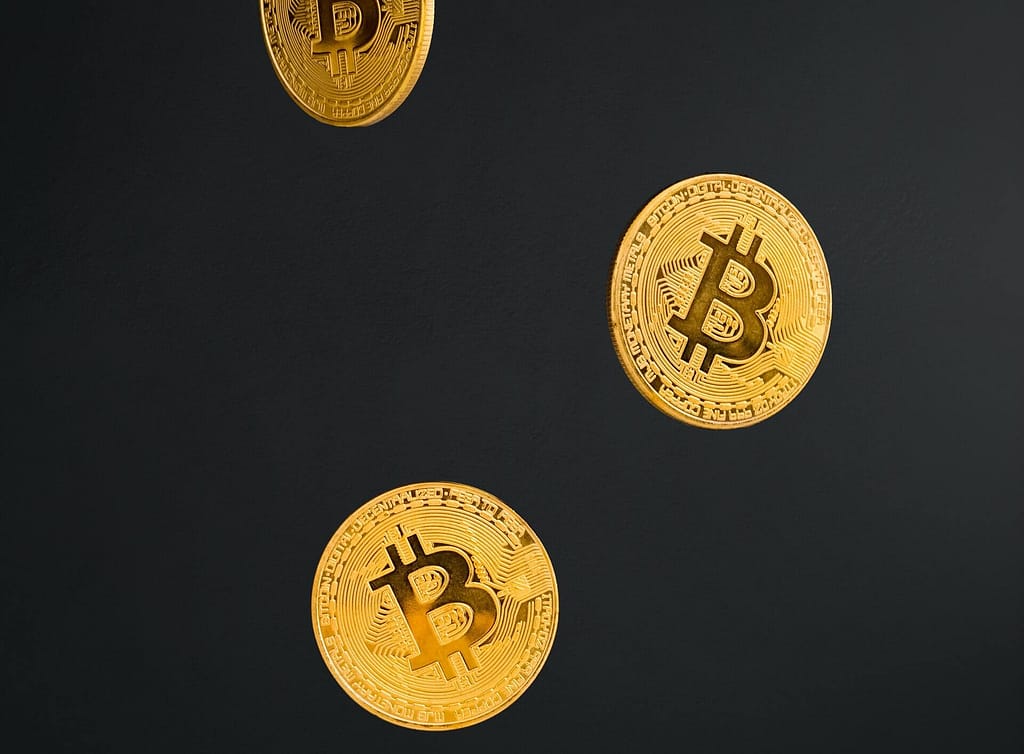 Pièces de monnaies frappées de symbole du bitcoin qui tombent