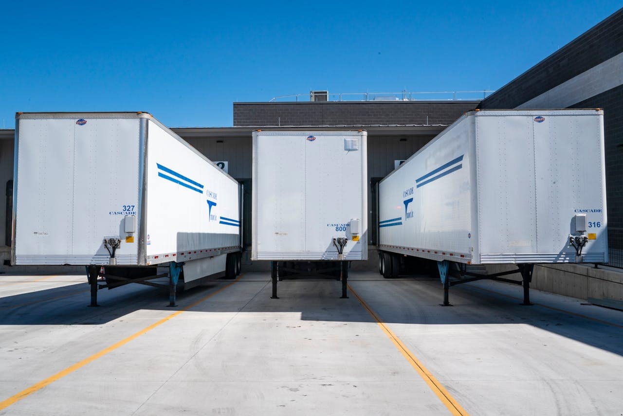 trois remorques frigorifiques sur une plateforme logistique