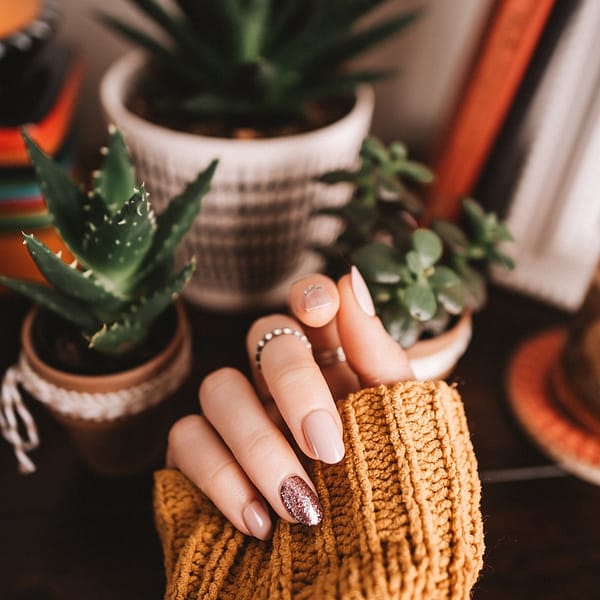 Main de femme avec du vernis à ongles de différentes couleurs