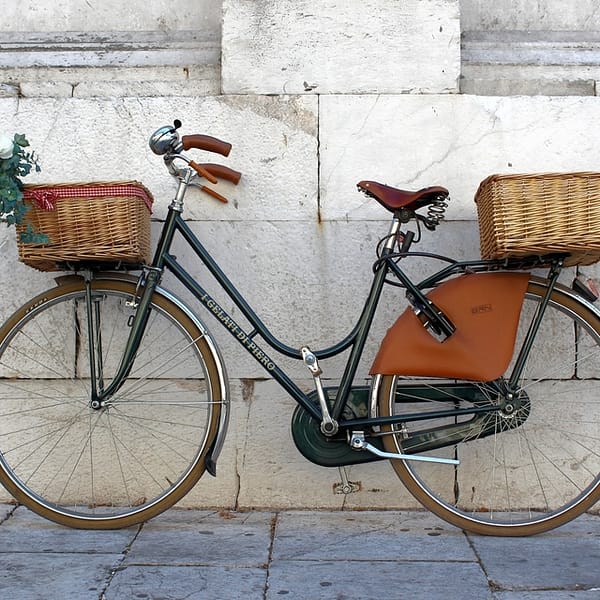 vélo vintage avec des paniers un osier photographié dans une rue