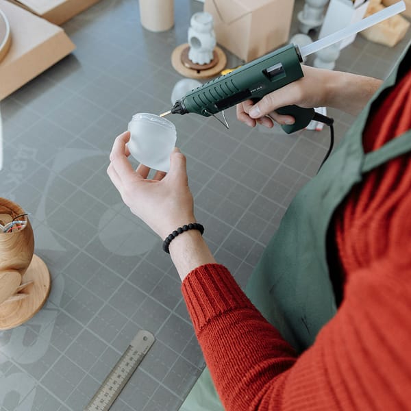 un bricoleur utilisant un pistolet à colle